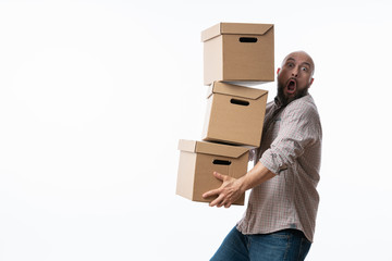 Young man carrying and dropping his stack of moving boxes