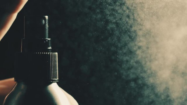 Pushing button on the spray bottle, super slow motion. Shot on Red