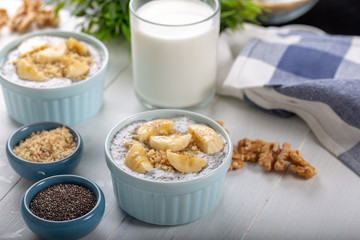 Chia pudding made with milk, banana and decorated with walnut