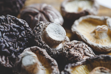 Macro photography of Chinese dried mushrooms Shiitake on a wooden kitchen board.