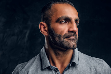 Close-up a handsome Caucasian male wearing a gray shirt.