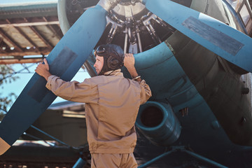 Aviator is checking  jet before departure.