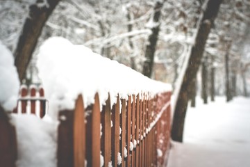 wooden fence in snow