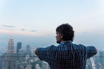 Man looking the skyline of Kuala Lumpur, Malaysia