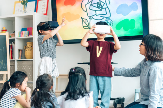 Preshool kids wearing virtual reality headset in classroom