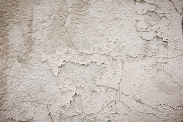 Gray cement wall with traces of the brush on the crumbling plaster. textural composition