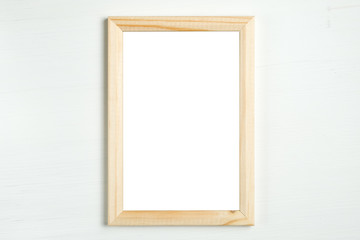 Rectangular wooden vertical frame on a white wooden background.