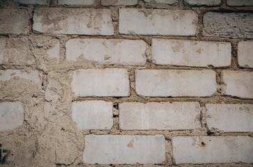 Close Up of an Old Exterior Brick Wall with Stained and Peeling White Paint