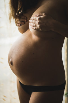 Topless pregnant woman