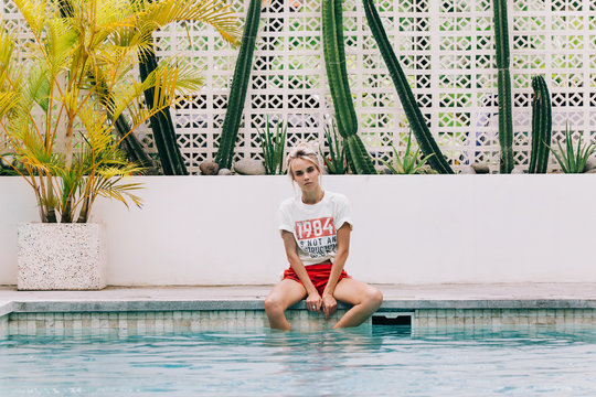 Young Pretty Rebel Girl Sitting by Swimming Pool in Tropical Bea