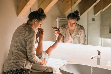 Woman changing her baby's diaper