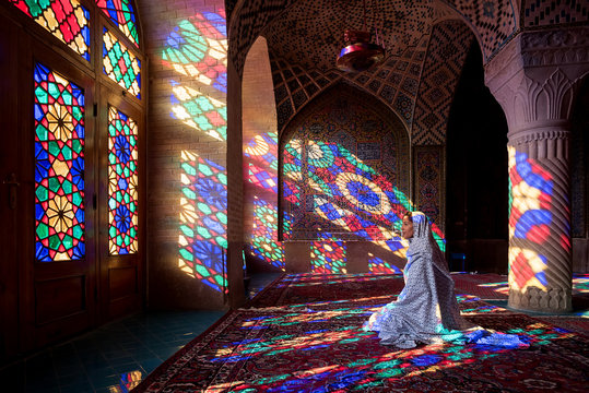 Anonymous woman inside of colorful oriental mosque