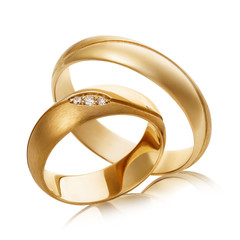Two gold wedding rings with diamonds isolated on white background. The photo was taken by stacking