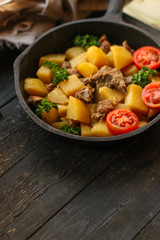 stewed potatoes with meat, goulash. stewed main course. food background. top