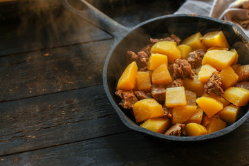 stewed potatoes with meat, goulash. stewed main course. food background. top