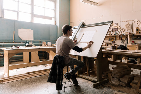 Professional craftsman making blueprint