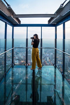Tourist taking pictures of Kuala Lumpur's skyline