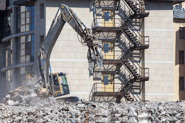 hydraulic excavator on construction debris