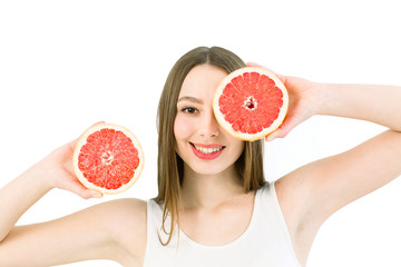 Healthy, beautiful smile, cute happy girl holding halves of grapefruit near face. Healthy food concept. Skin care and beauty. Vitamins and minerals. Isolated on a white background