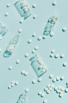 Overhead view of pills with bottles on table