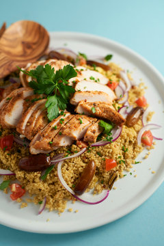 Chicken and couscous salad on a plate.