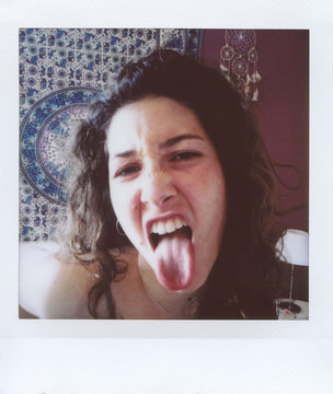 Brunette sticking out tongue at camera.