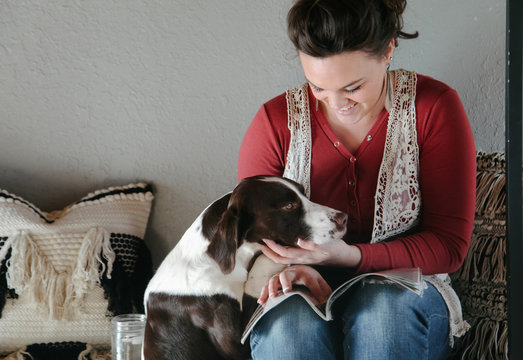 woman gives her dot attention while relaxing
