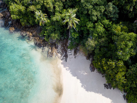 Drone shot of green island in emerald waters in Kapas, Malaysia