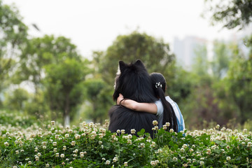 Young asian woman with her dog outdoor