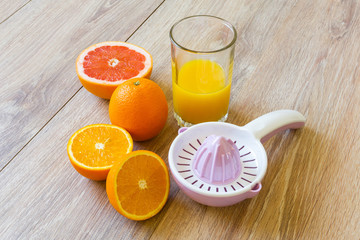 various citrus fruits, reamer and juice