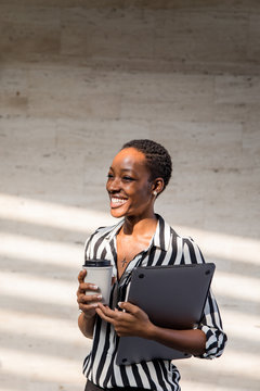 Portrait of a woman with laptop and coffee