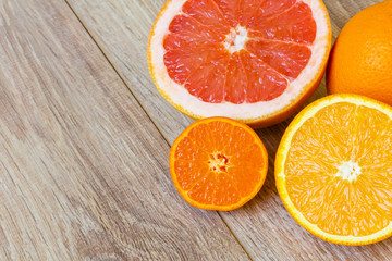 various citrus fruits on wooden table