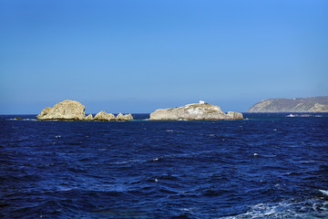 Fototapeta na wymiar sea landscape and cliffs with a small solitary church near the island of Paros