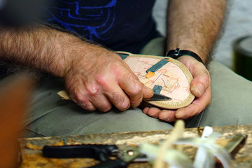  Artisans of the shoe at work in the center of Parikia