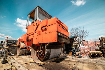 Fototapeta na wymiar Heavy vibration red road roller compactor on the transport trailer truck