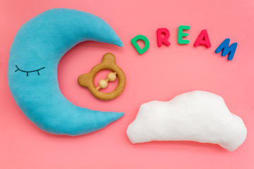 dream copy for baby pattern with moon pillow, cloud, toy on pink background top view