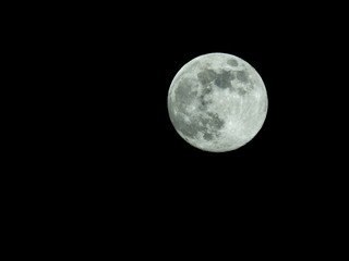 a full moon in the starry night sky