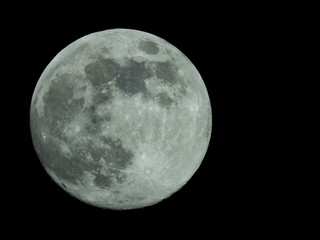 a full moon in the starry night sky