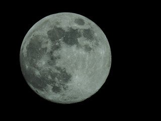 a full moon in the starry night sky