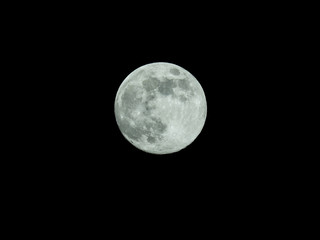 a full moon in the starry night sky