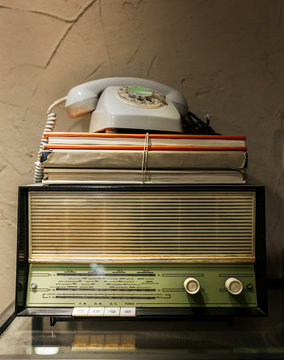 Antique radio, telephone and books