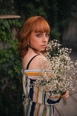 Redhead with plants in the hand