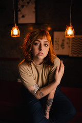 Redhead Girl with two lamps in background