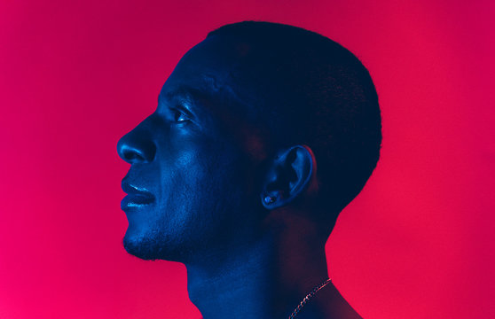 Portrait Of A Man Under Blue And Red Lights