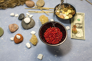 composition with scales, red pepper and coins