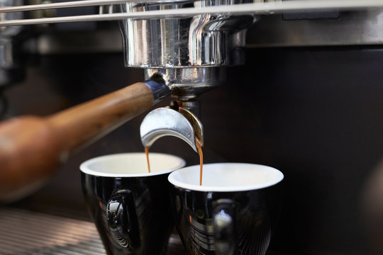Espresso machine filling two cups of coffee