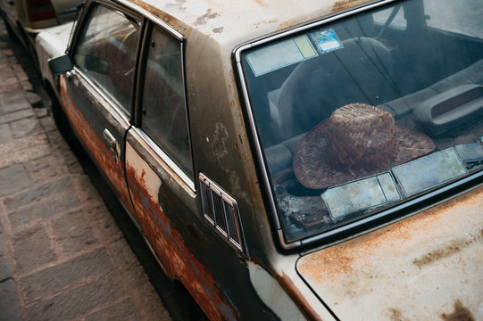 Old weathered car in Mexico with Sombrero hat