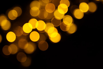 Abstract gold bokeh on black background. Defocused yellow lights, abstract texture © Iryna Budanova