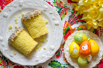 Easter cake with eggs and a bouquet of flowers