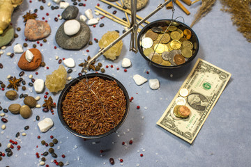 Fototapeta na wymiar composition with scales, red rice and coins